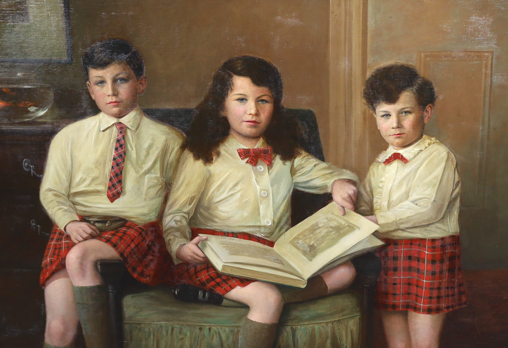 J.W. Beaufort (fl. circa 1920-30), Portrait of three Scottish children in a drawing room, all wearing Cameron tartan kilts, oil on canvas, 87 x 125cm